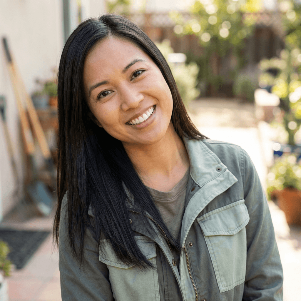 Aisha Khan, female homeowner in her early 30s, East Asian, casual friendly appearance, on a residential front lawn